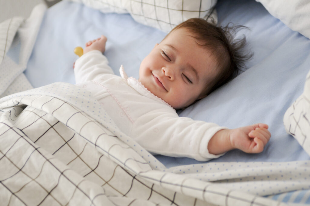 Peacefully sleeping baby showing natural baby sleep cycles explained in the blog
