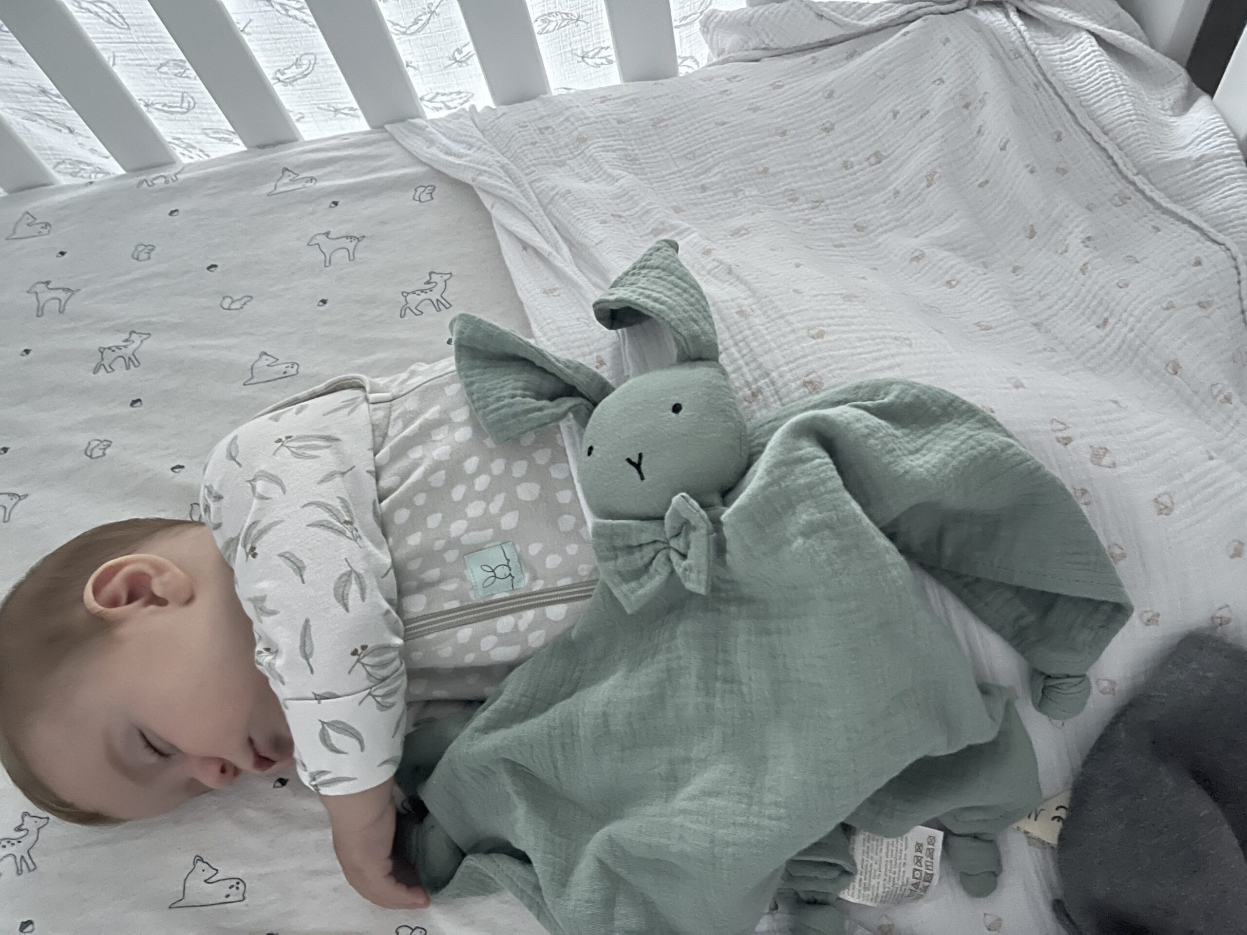 Baby wearing a TOG-rated sleeping bag to stay warm and safe while rolling – baby rolling over tips for comfort and safety.