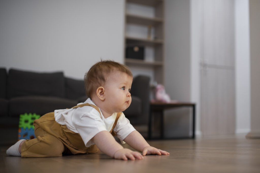 Baby in crawling position during a developmental leap, a stage that can impact sleep patterns if foundations aren’t in place.