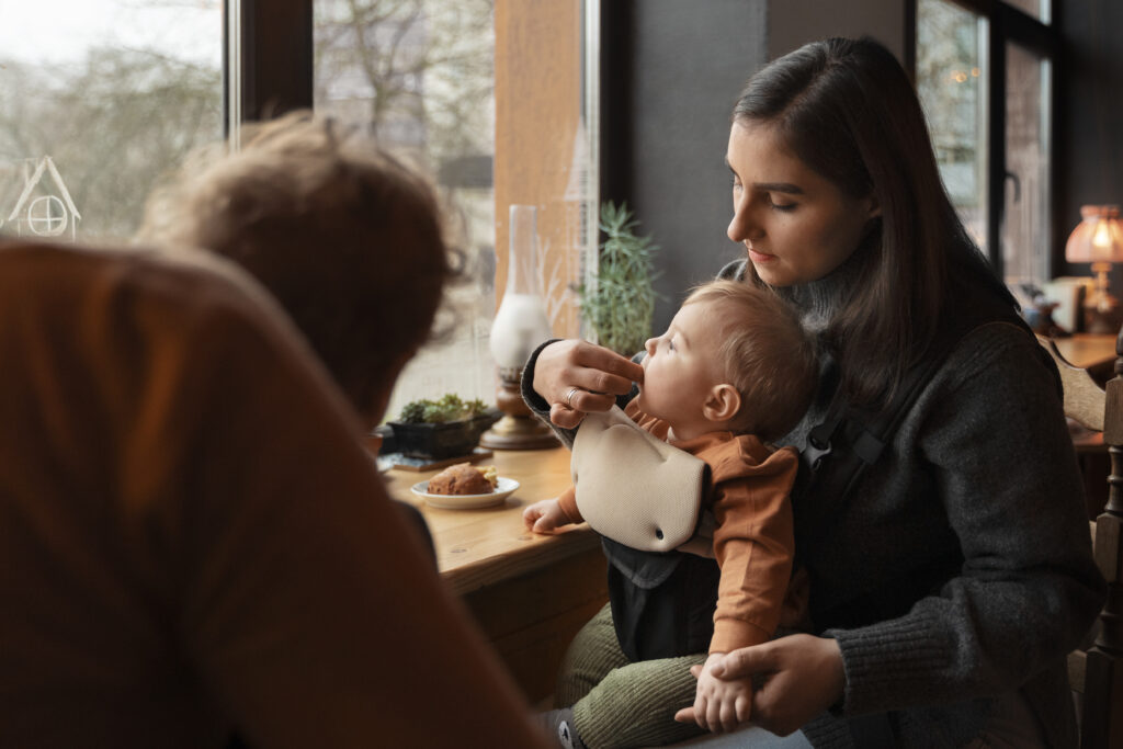 Mother introducing allergy-safe foods to baby in a calm, supportive setting.