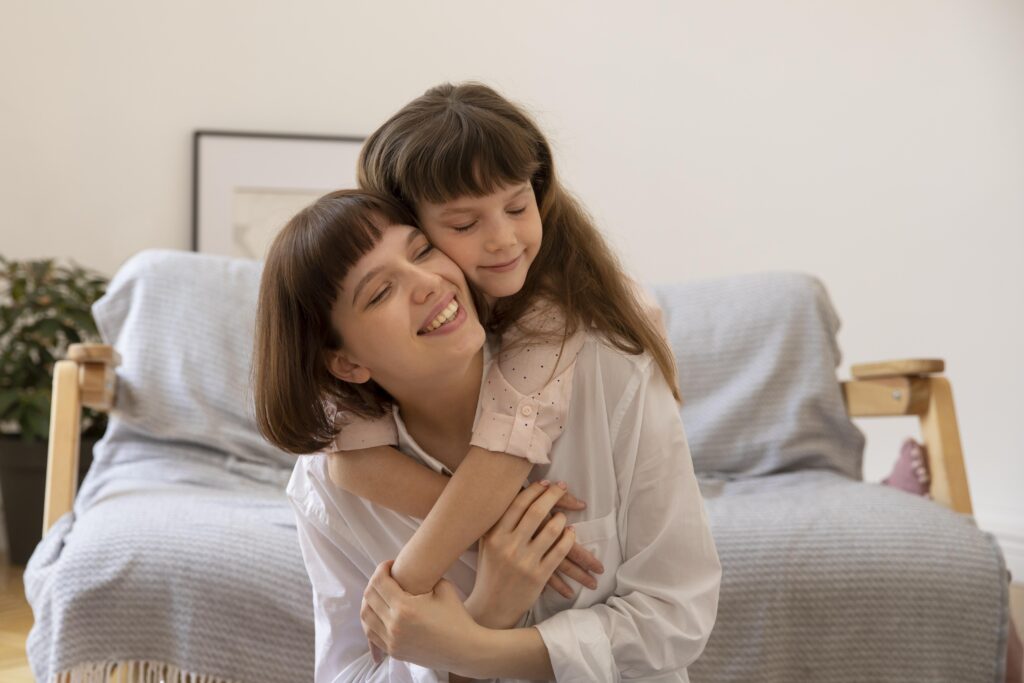 Toddler laughing while holding hands with a childcare educator, capturing starting childcare tips for building trust and confidence over time."