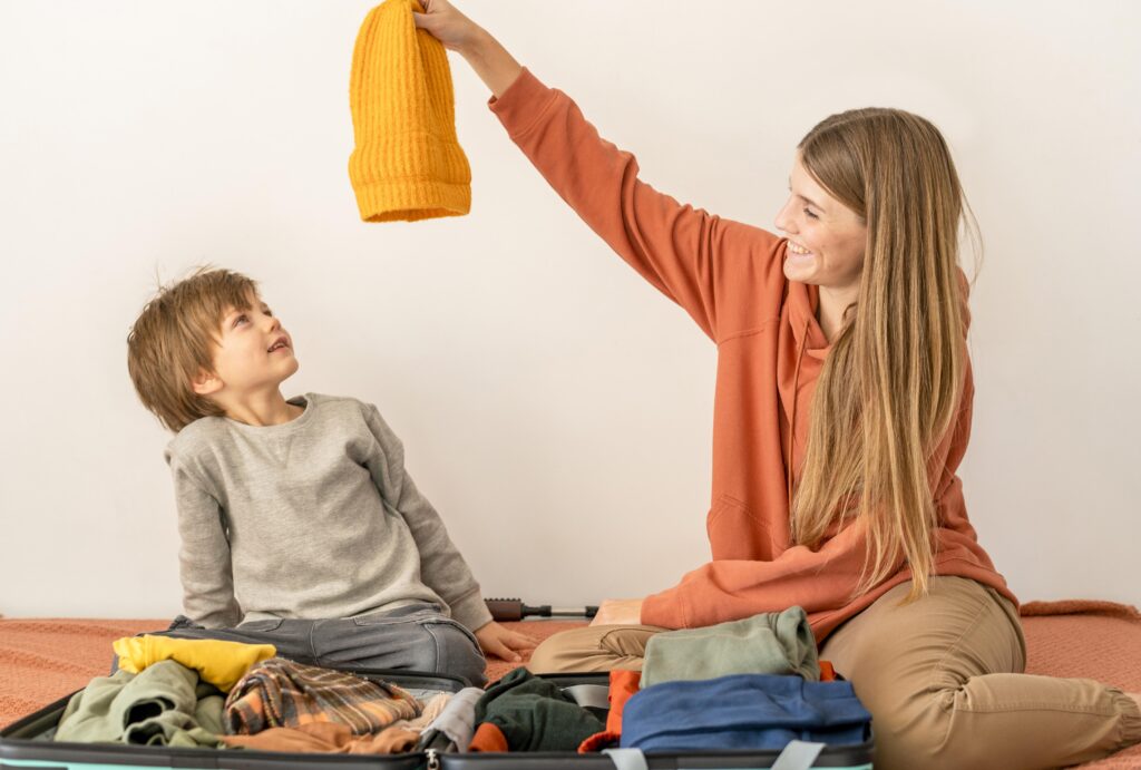 Toddler enjoying messy play with paint at childcare, wearing comfortable clothes—practical starting childcare tip for everyday care.